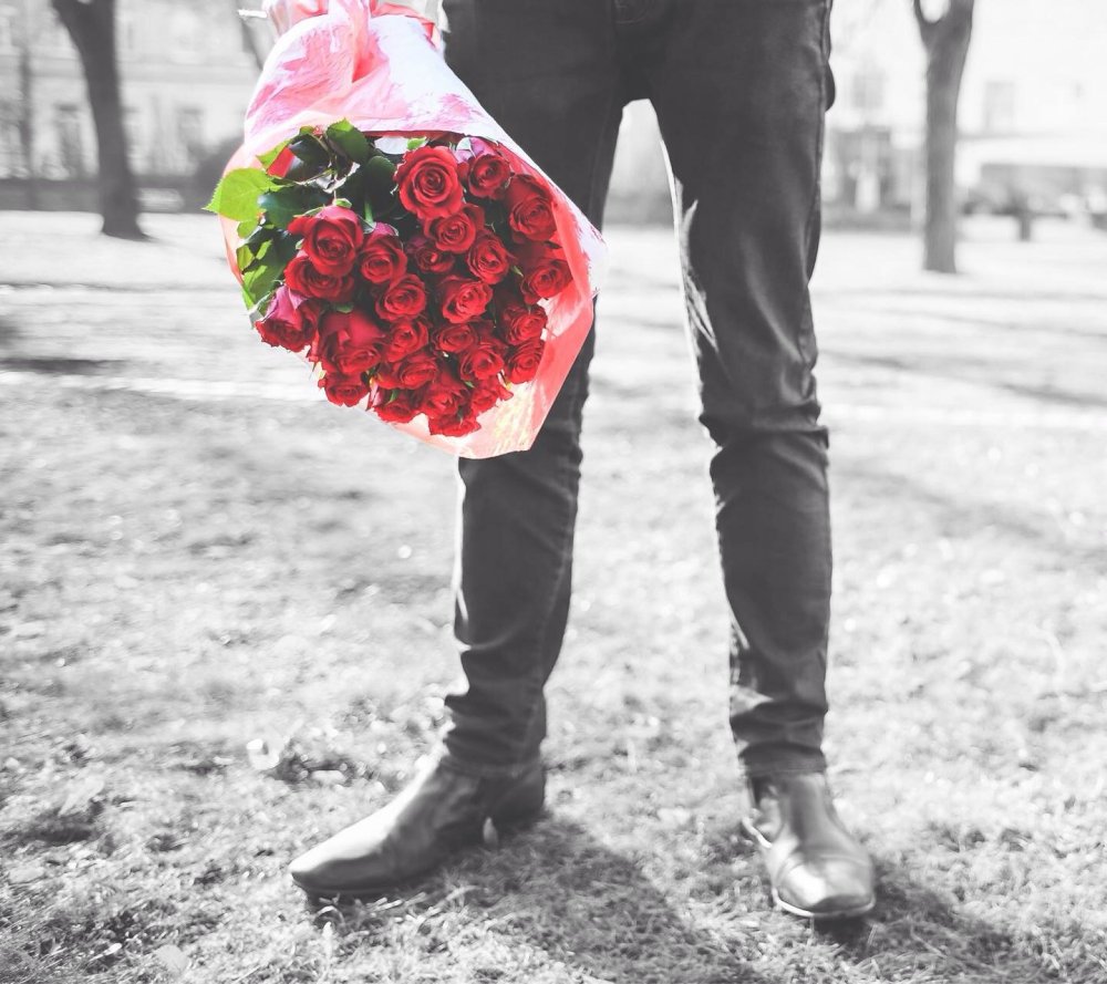 Мужчина с букетом красных роз